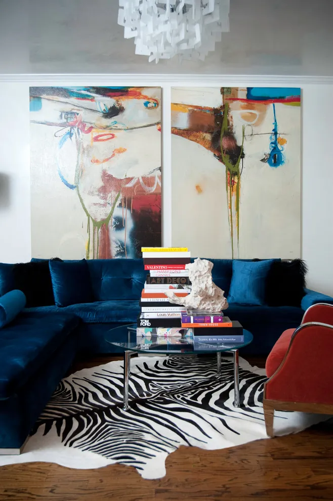 Two large abstract canvases above deep blue seating