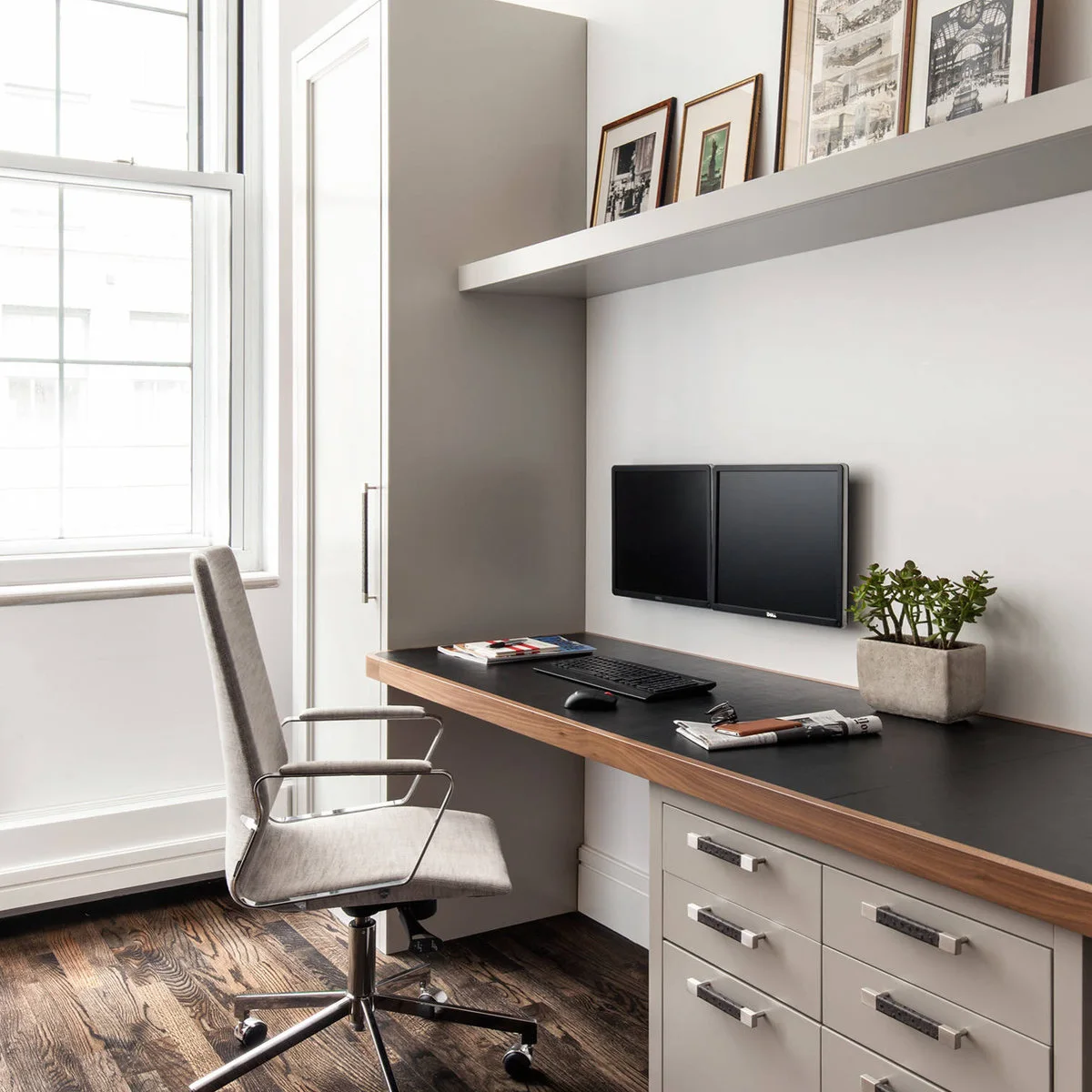 Narrow home-office counter with drawers at one end and a tall cupboard beside the window
