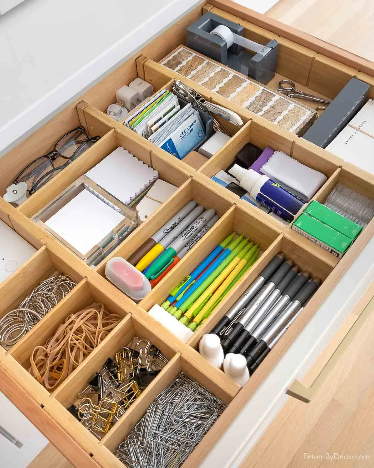 Wooden divided drawer with stationery, glasses, small cards, clips and cleaning cloths