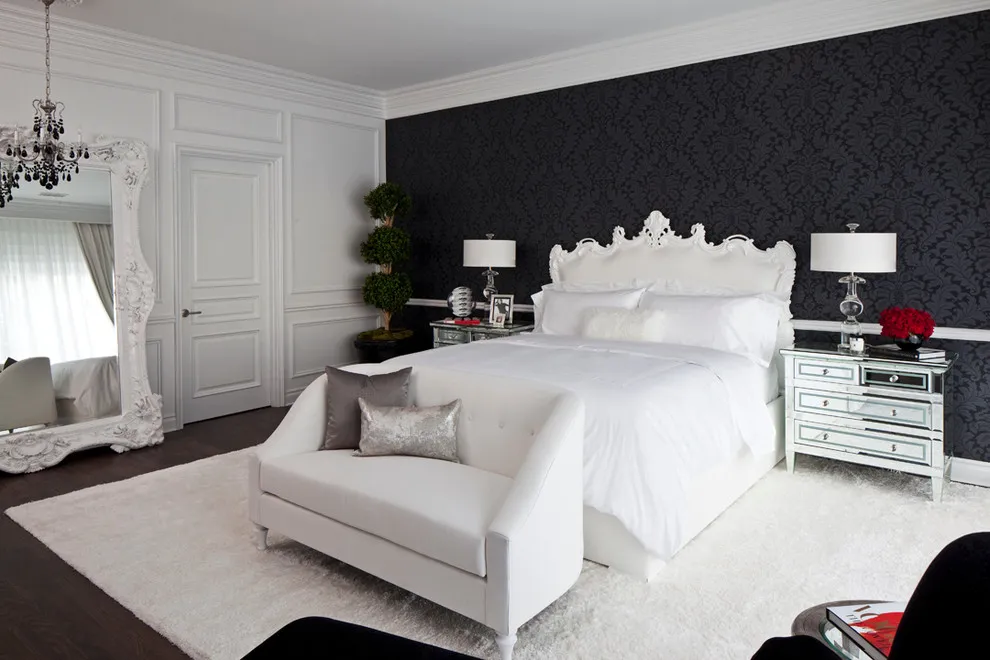 Pale upholstered seating and bedding sit beneath a dark textured bedroom wall