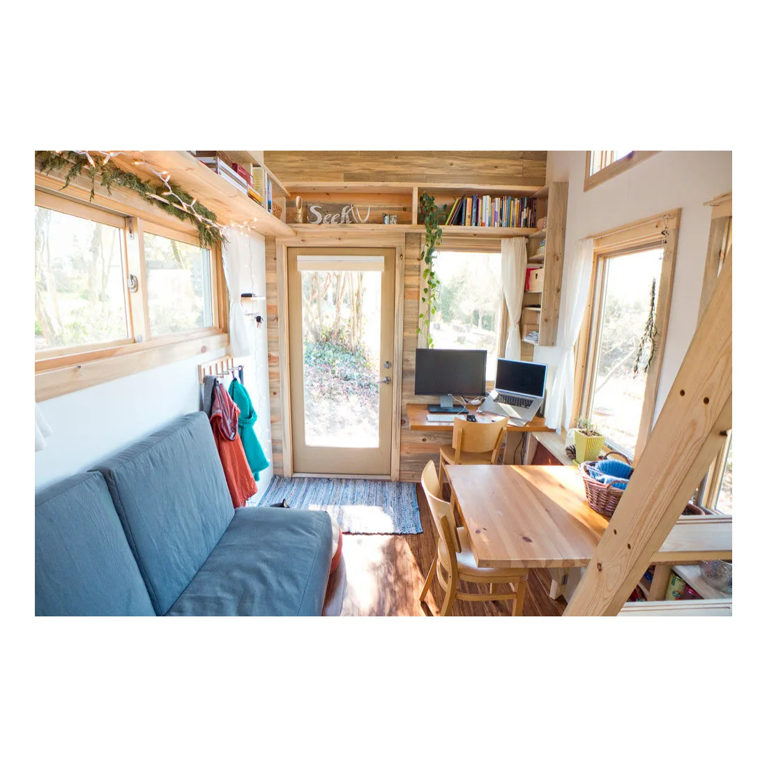 Small dining table and blue bench seating with a computer desk beside the back window