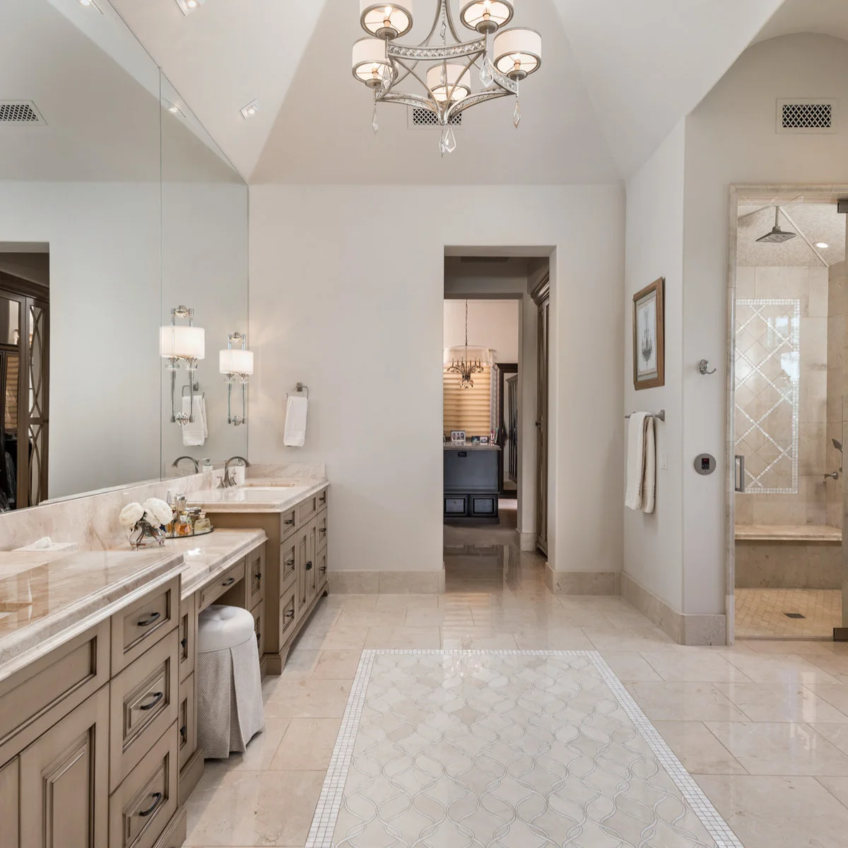 Large frameless bathroom mirror following a long vanity beneath a sloping ceiling