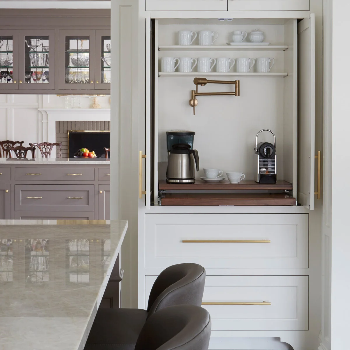 White coffee cupboard with mug shelves, two coffee makers and a projecting wooden shelf