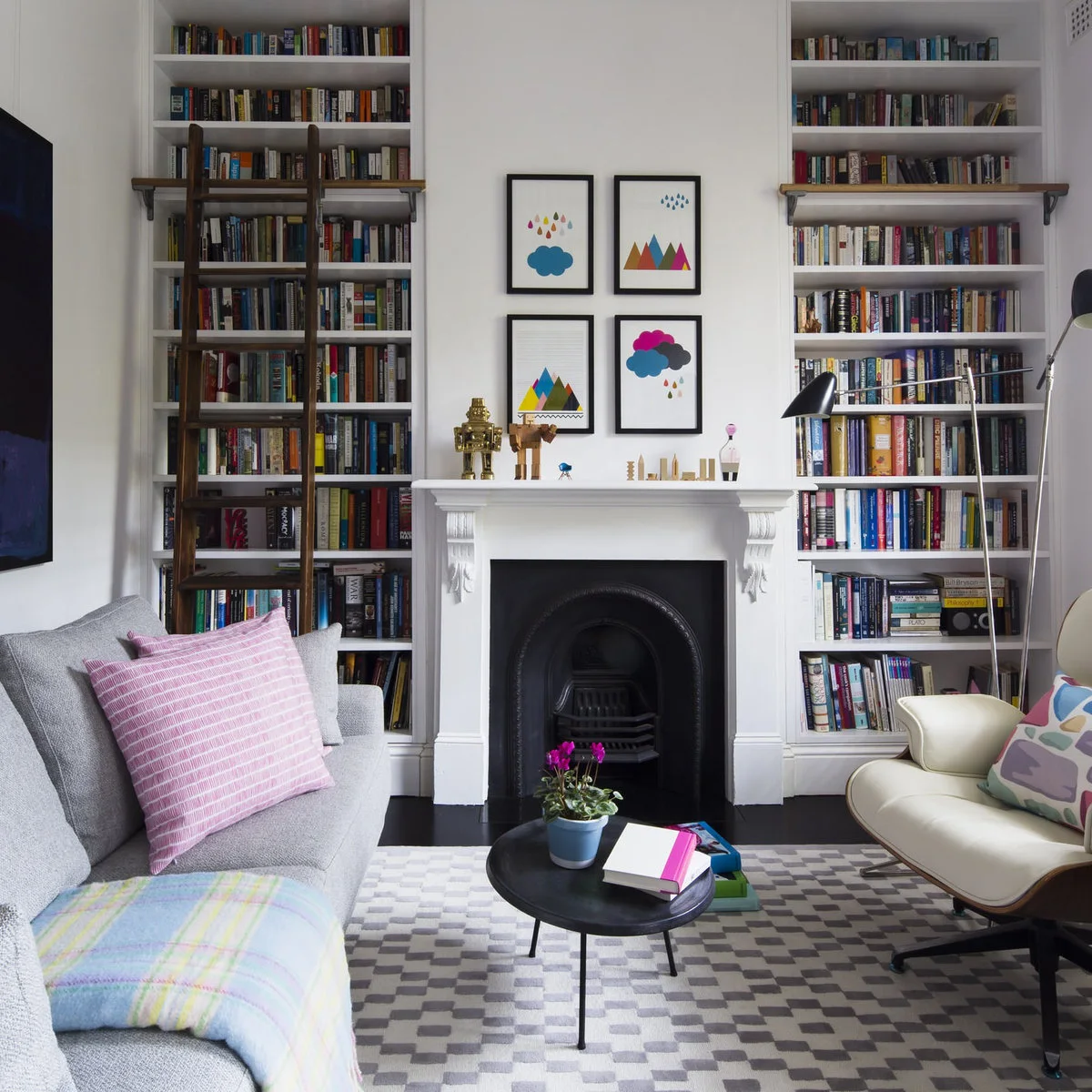 Darlinghurst terrace with tall book-filled alcoves, rolling ladder and small round coffee table