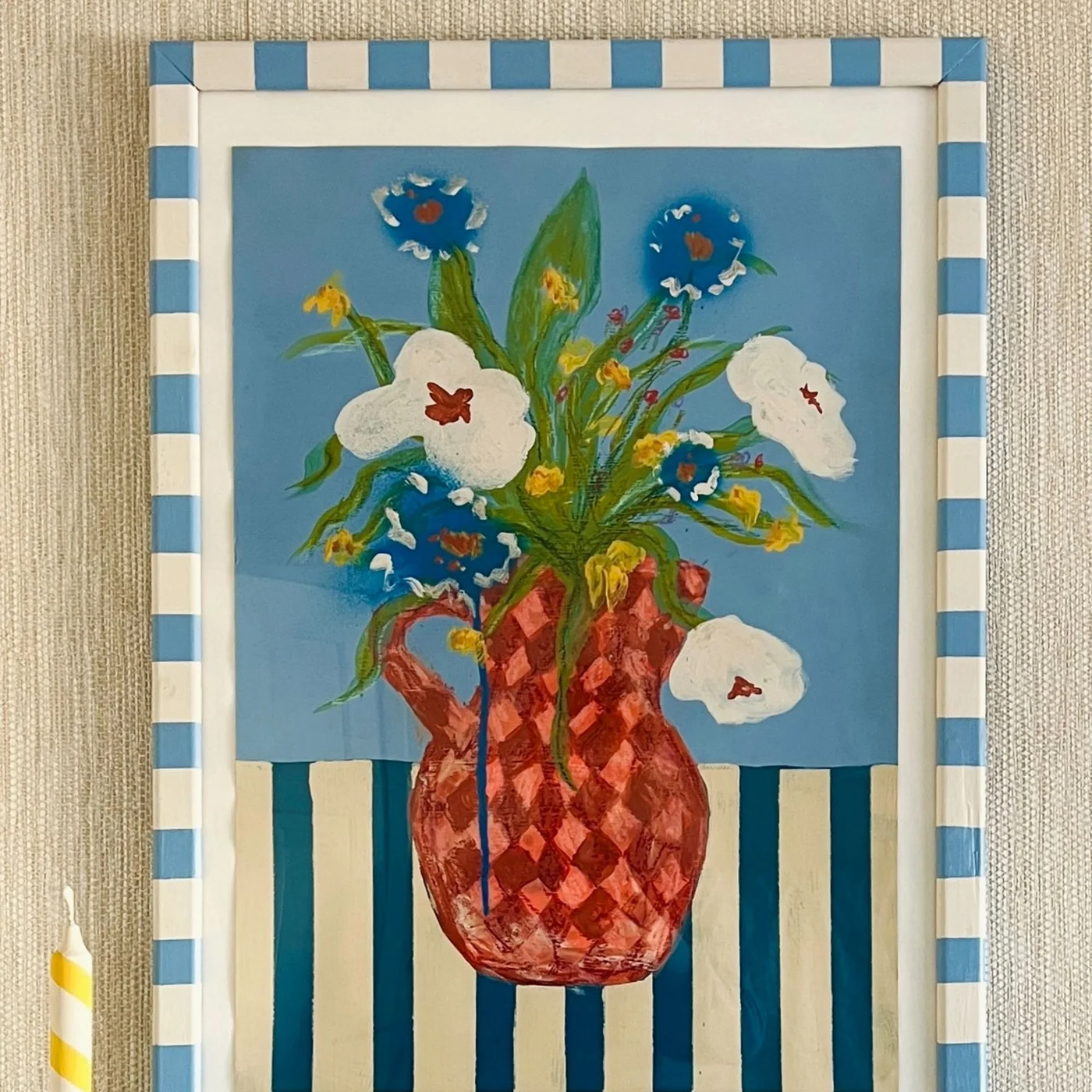Blue-and-cream striped picture frame surrounding a colorful floral painting