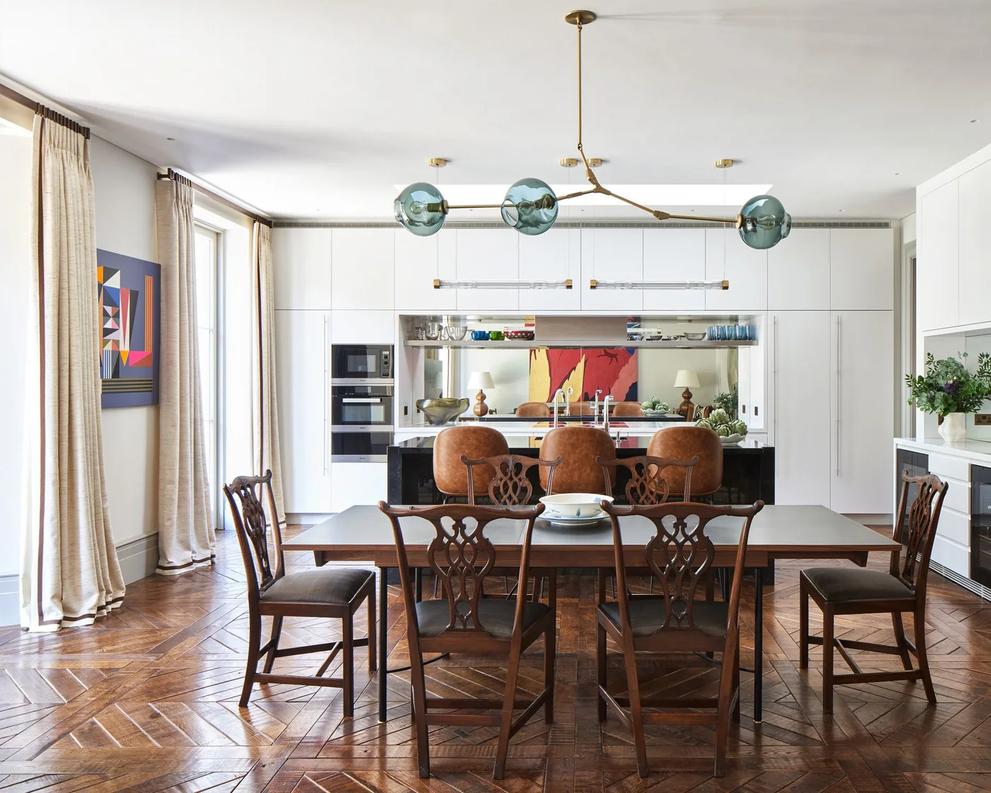 Beige curtains with narrow dark lower stripes beside kitchen dining doors