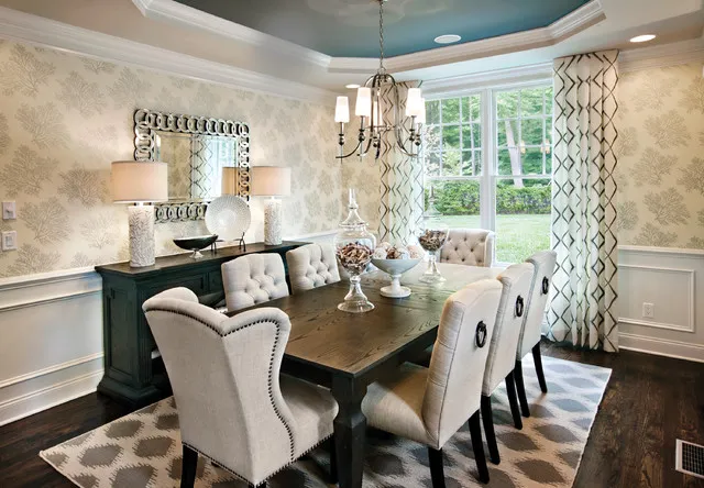 Quiet patterned walls sit below a pale blue inset ceiling and chandelier.
