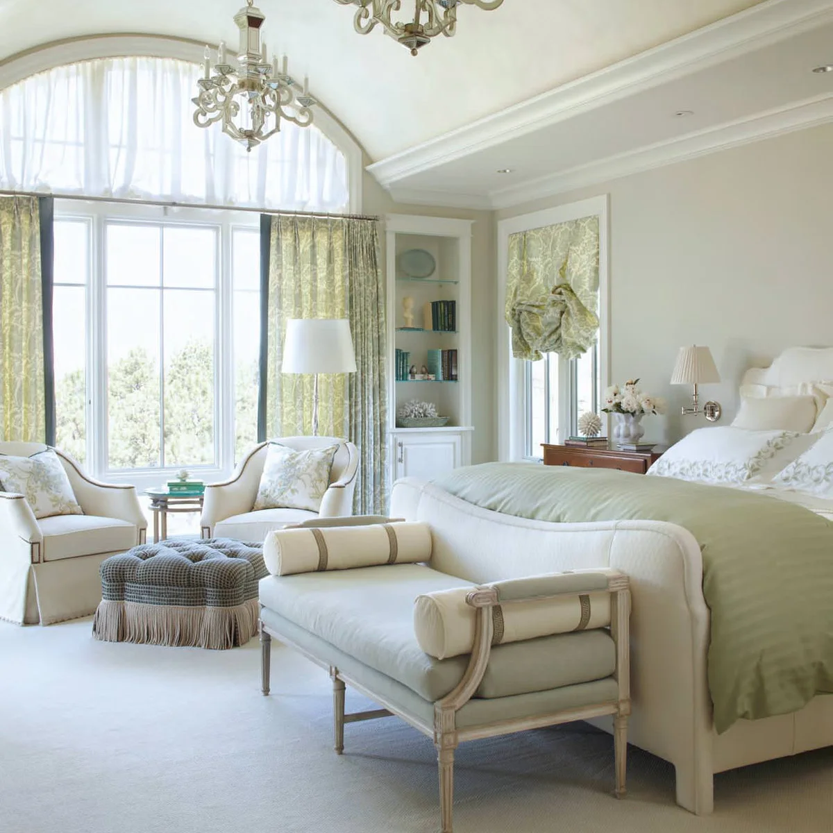 Pale upholstered bedroom bench with curved ends and cylindrical bolster cushions