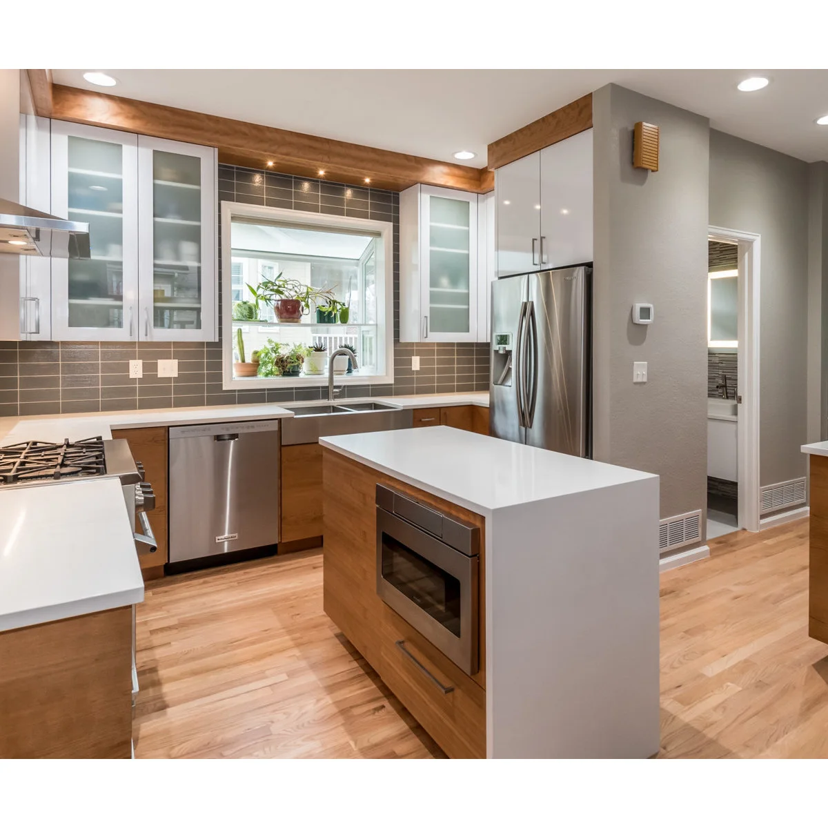 Small wood kitchen island with a white waterfall end and an inset appliance