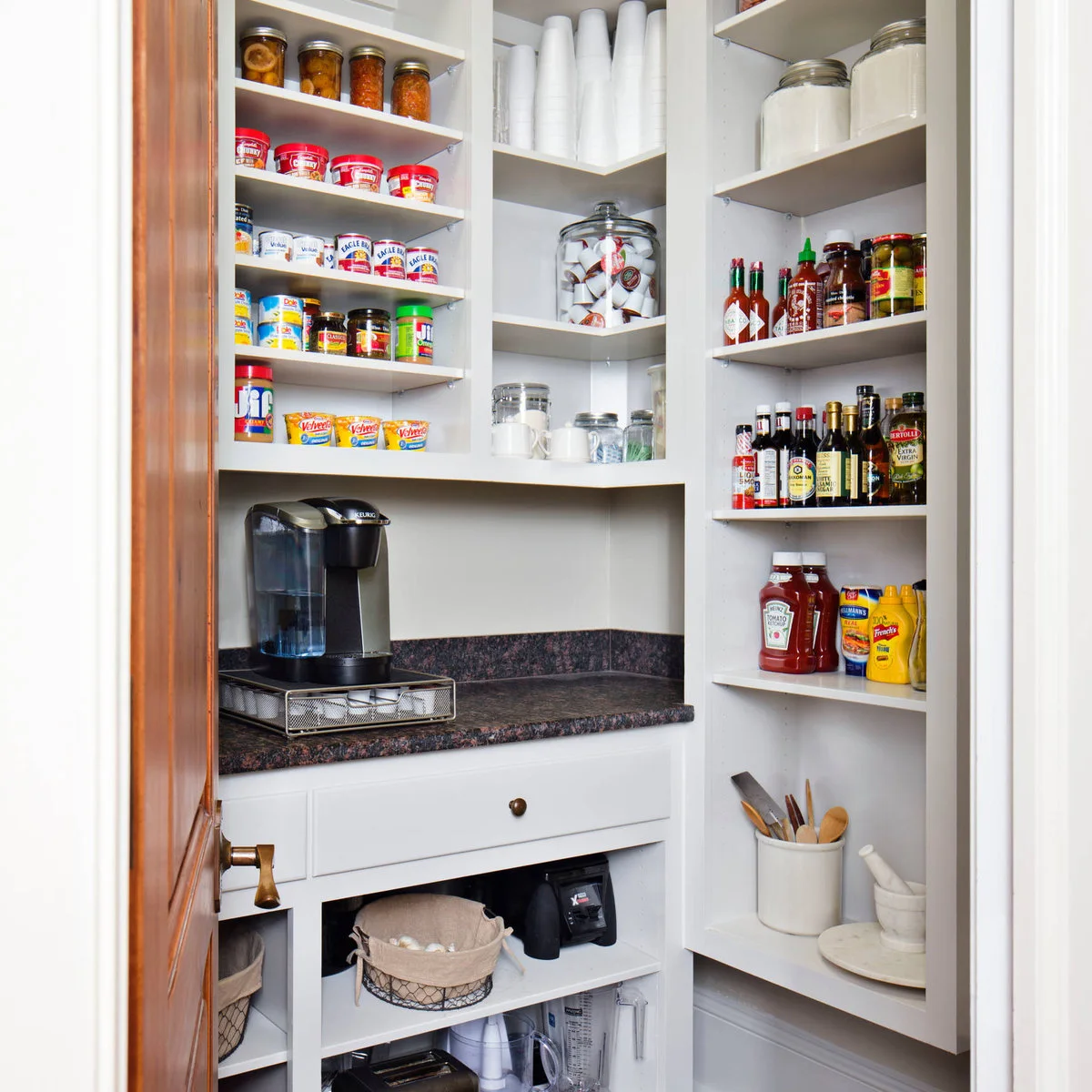 Small pantry with a coffee maker, corner shelves and grouped food jars