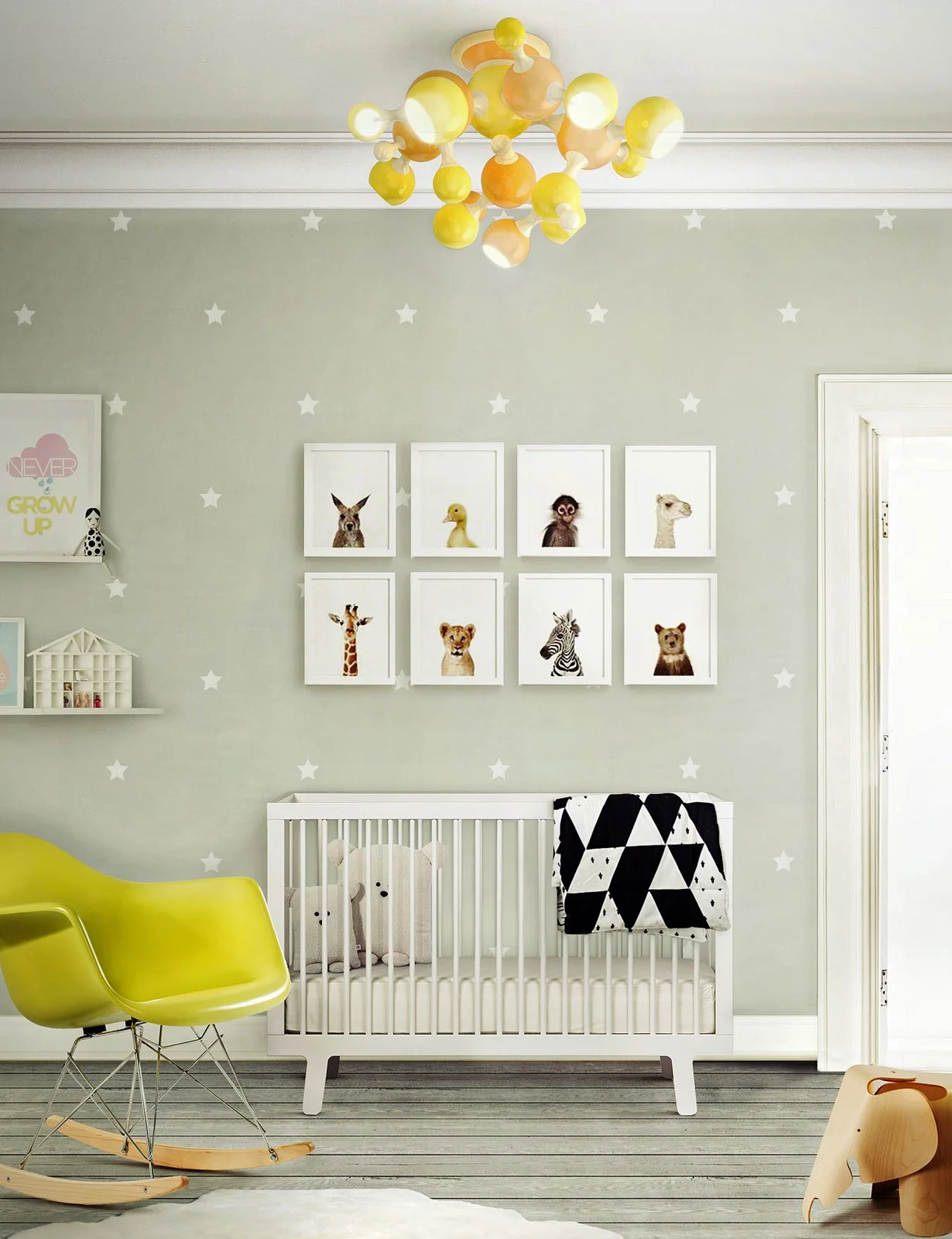 Two rows of framed animal portraits hang on a pale star-patterned nursery wall above a white crib beside a yellow rocker and clustered yellow globe light