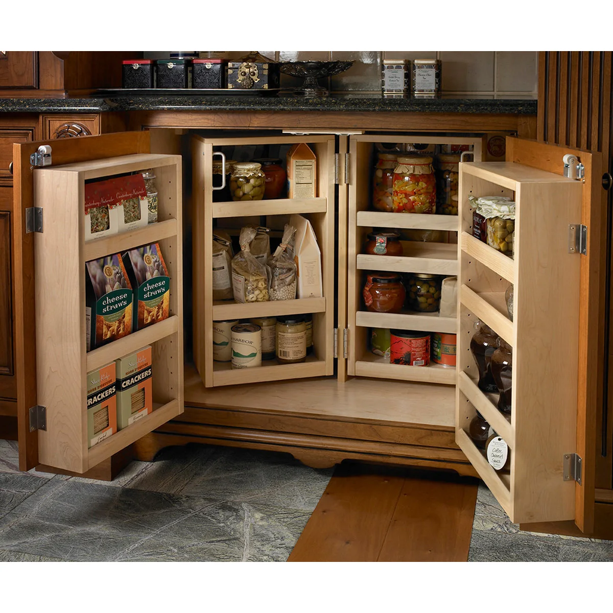 A lower wood cupboard opens to reveal door racks and inner swing-out shelves stocked with jars and packets.
