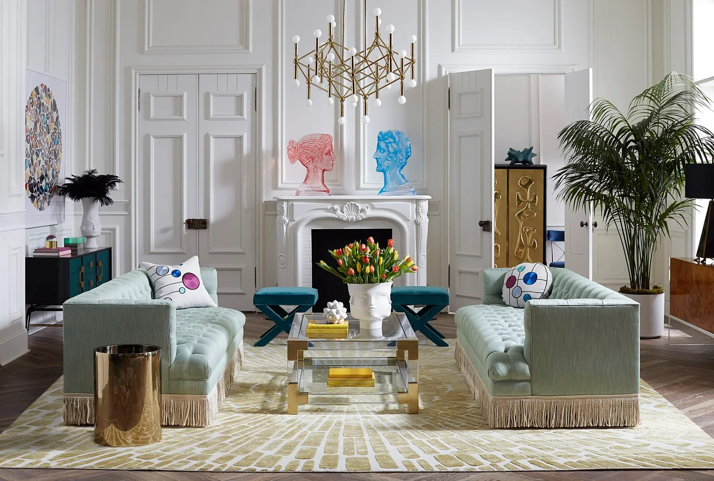 Clear coffee table with a white face vase of tulips and small yellow book stacks
