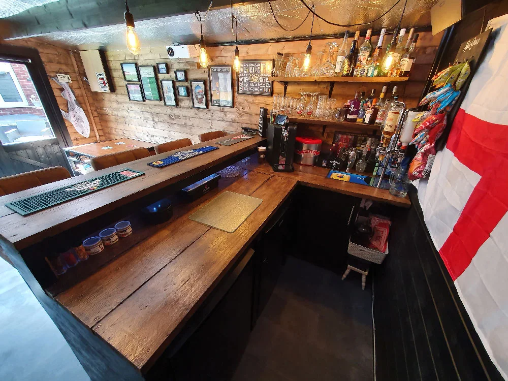 Shed pub interior with a raised guest ledge above a lower U-shaped working counter
