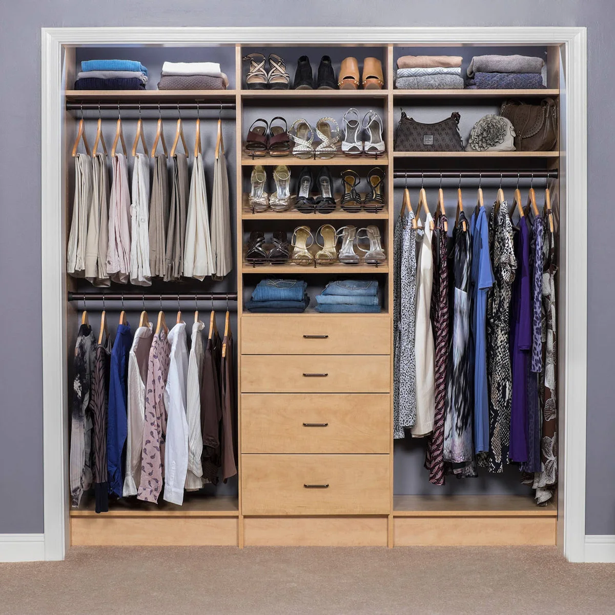 Reach-in closet with double hanging rails, central drawers and shelves for shoes, folded clothes and bags