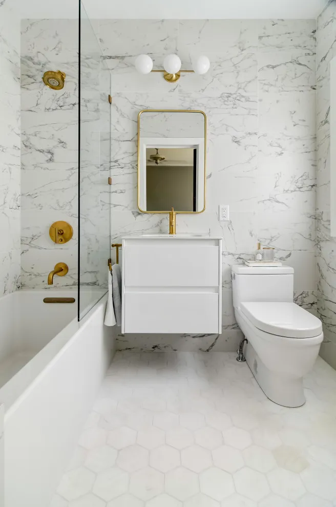 A pale floor sits beneath a compact vanity and strongly veined light walls
