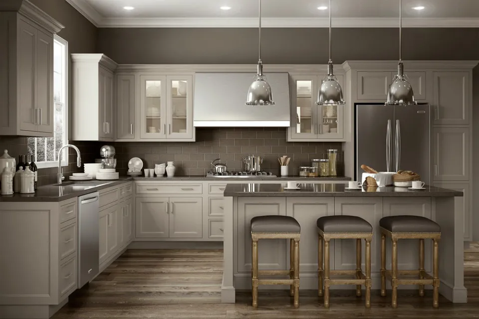 Taupe cupboards and walls surround an island beneath a row of metal pendants
