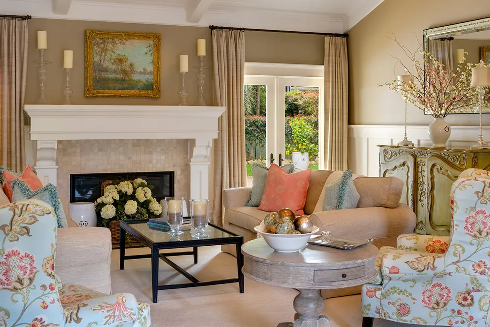 Beige sofas and colorful floral chairs with coral and blue cushions