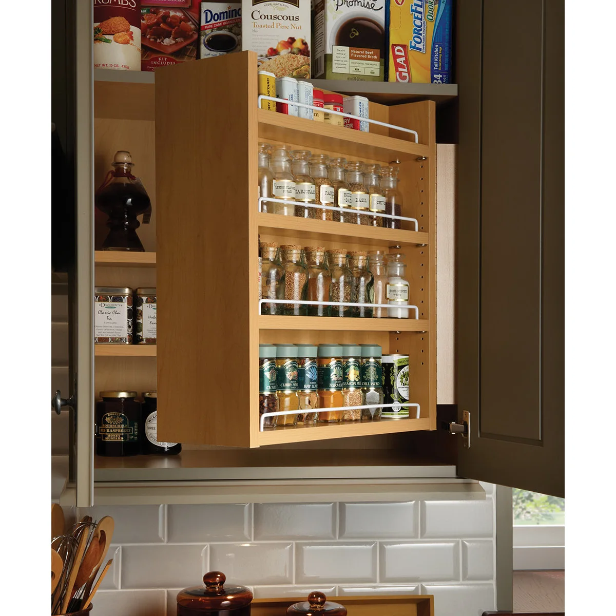 Wooden spice rack swung forward inside an upper kitchen cupboard