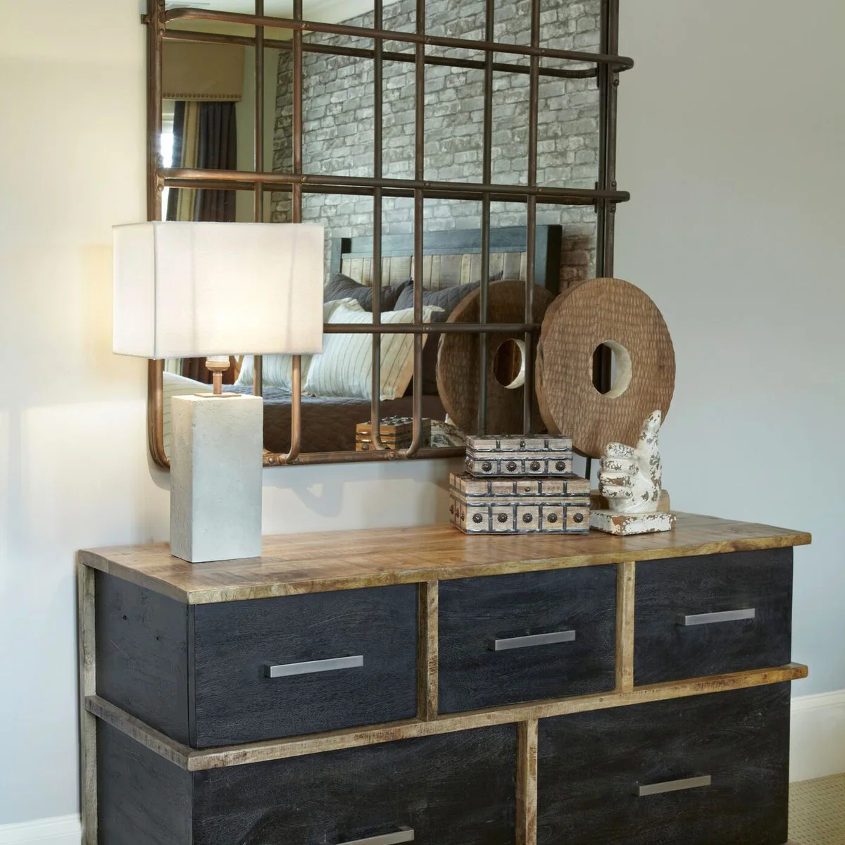 Teen bedroom dresser with dark drawer fronts, wood-colored edges and a large grid-framed mirror