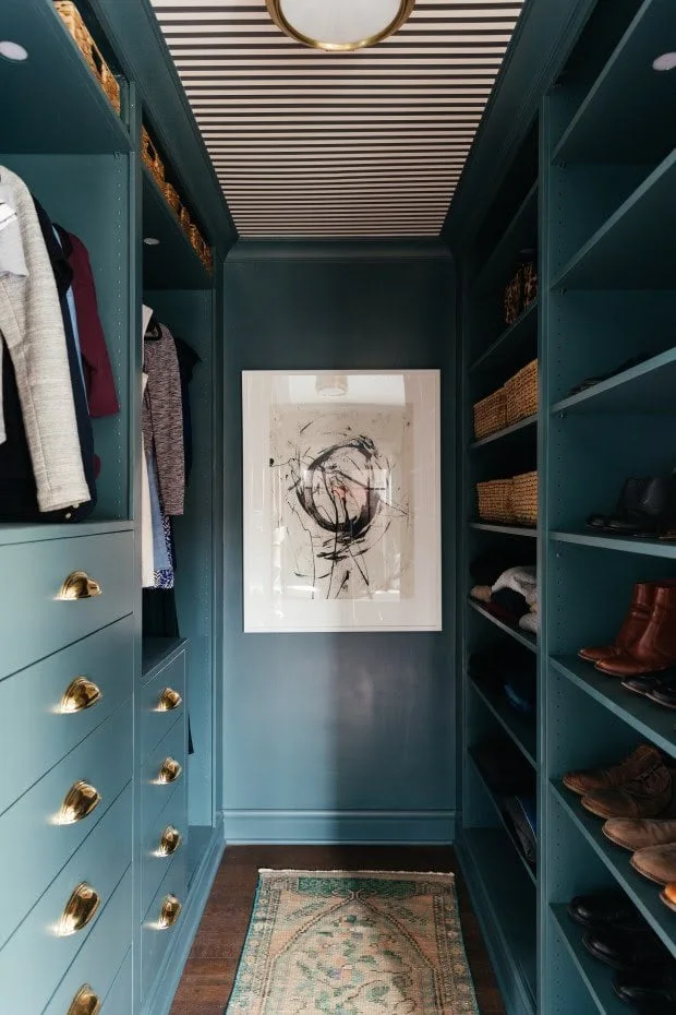 Blue-green PAX walk-in closet with drawers, open shelves, woven baskets and a striped ceiling