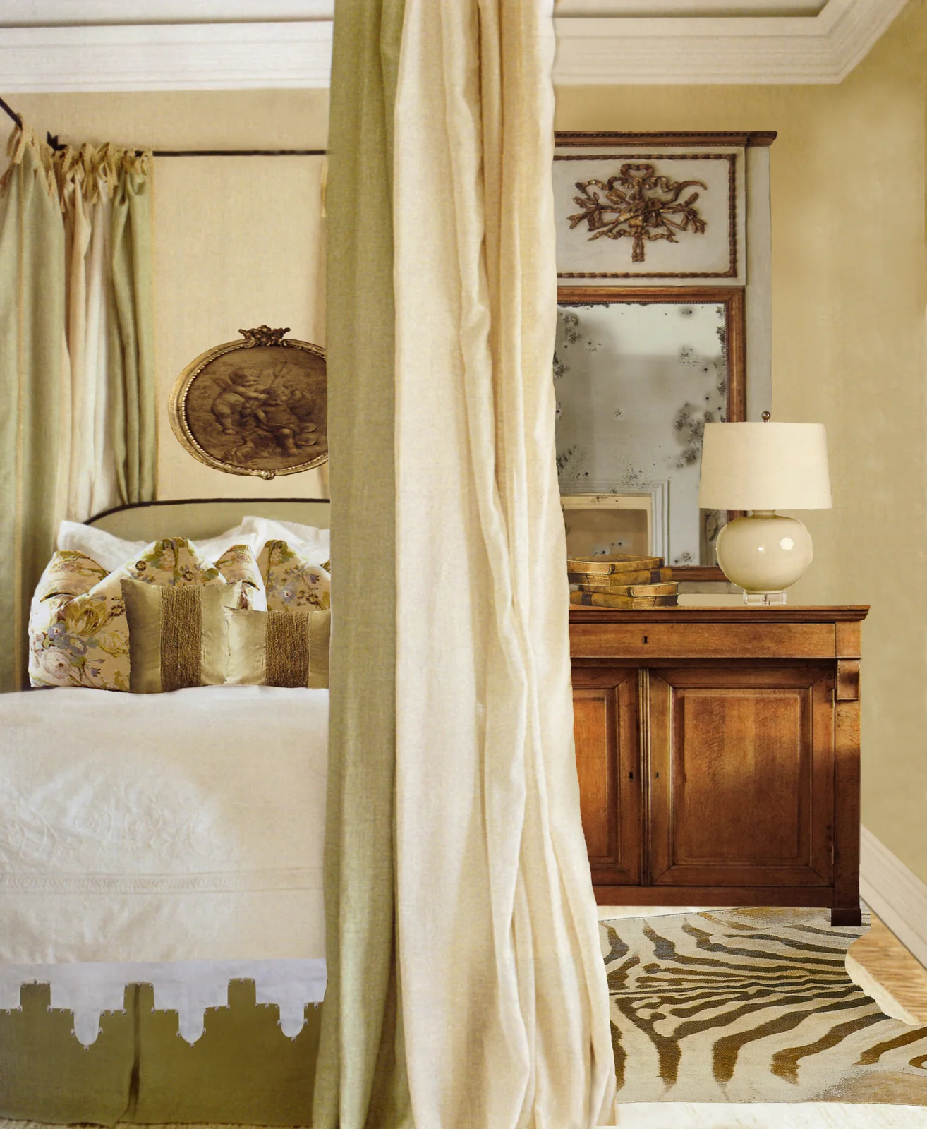 Traditional bedroom with pale canopy curtains, floral cushions and a wood bedside cabinet beneath a decorative mirror
