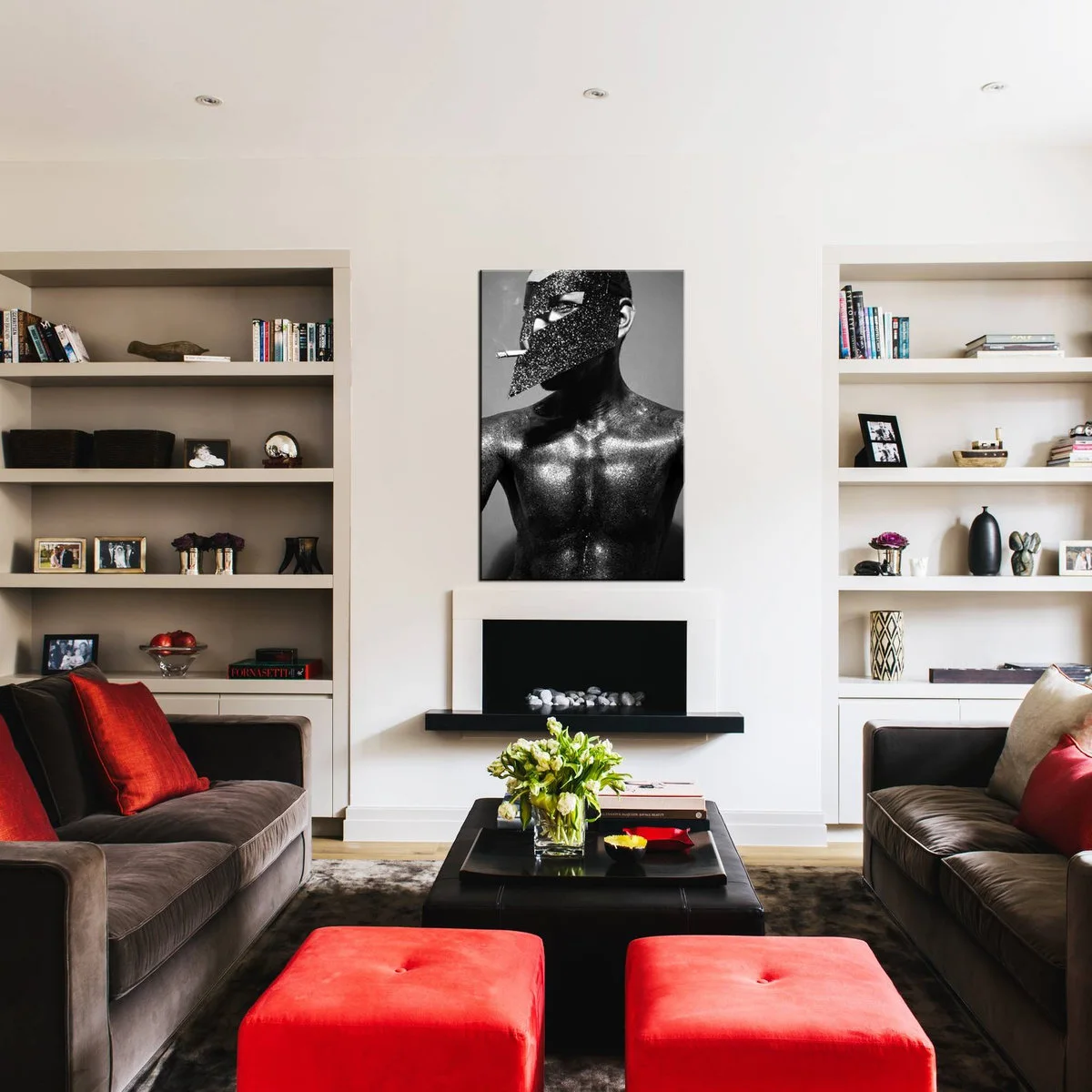 Two dark brown fabric sofas facing across a black ottoman with red cushions and two red stools.