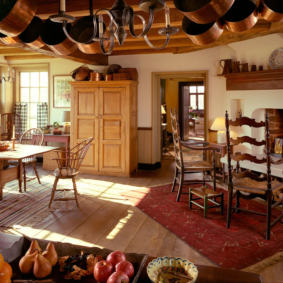 Checked café curtains at a country kitchen eating corner with wood furniture