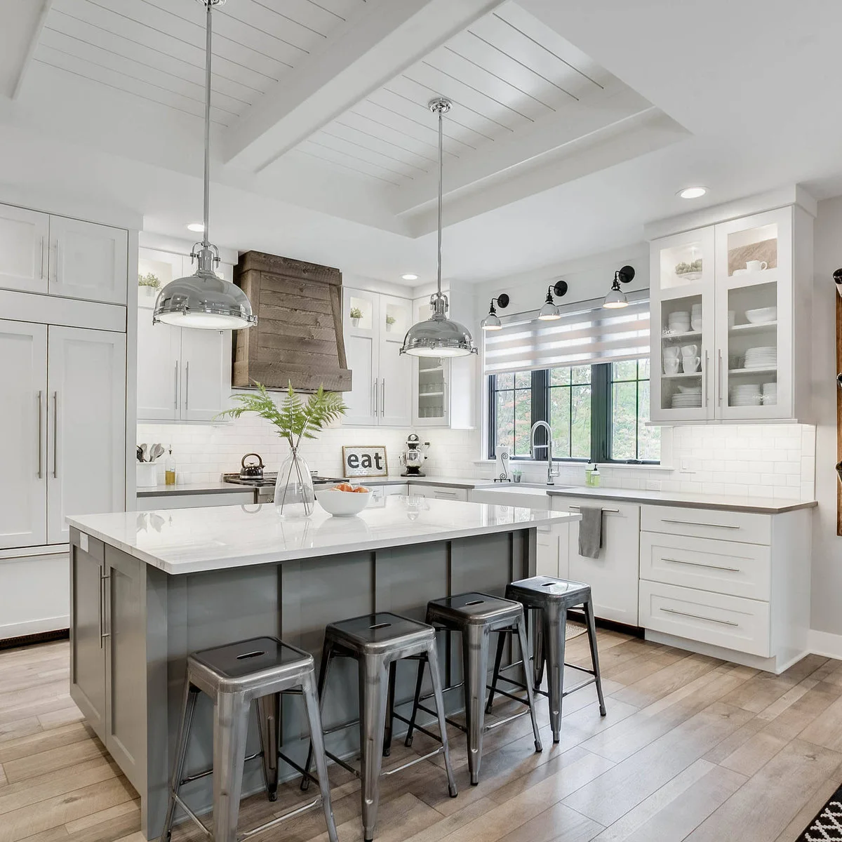 White paneled refrigerator doors sit below matching upper cupboards beside the main kitchen cabinets.