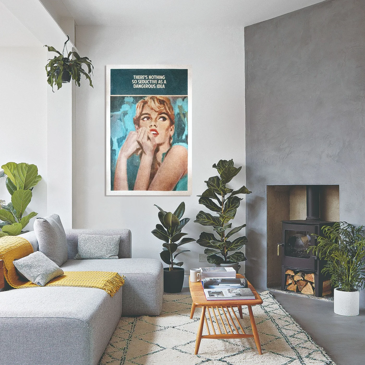 A gray chimney breast contains a dark stove beside a pale gray sofa, a wood spindle coffee table, a light patterned rug, yellow textiles and several floor plants.