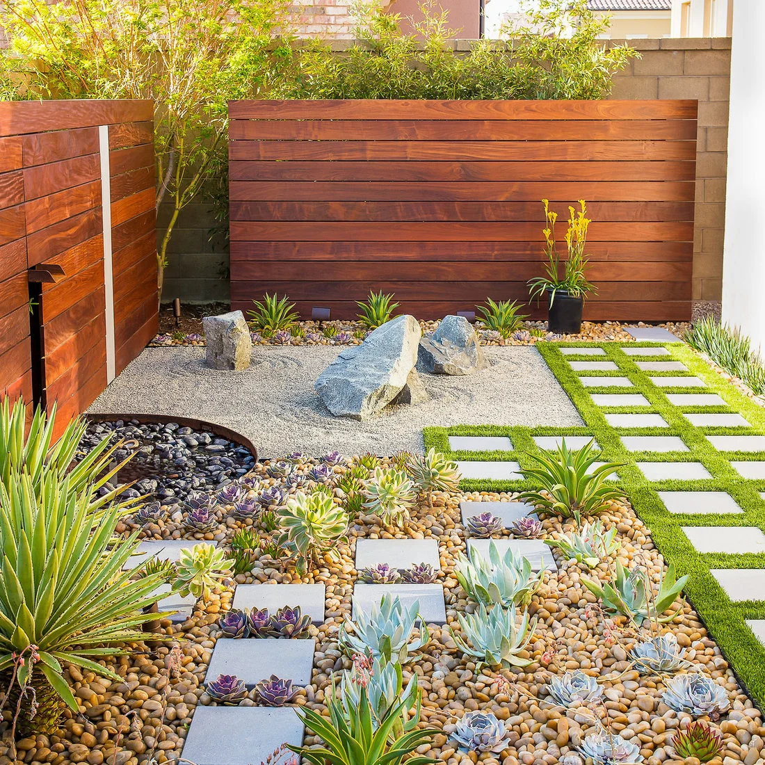 Horizontal timber screens surround a small gravel courtyard with planted beds