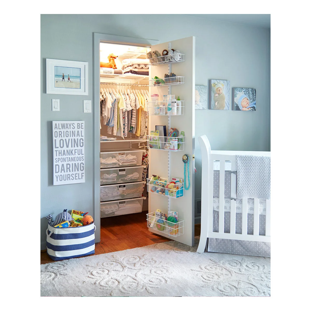 Open nursery closet with short hanging clothes, mesh drawers and baskets on the inside of the door