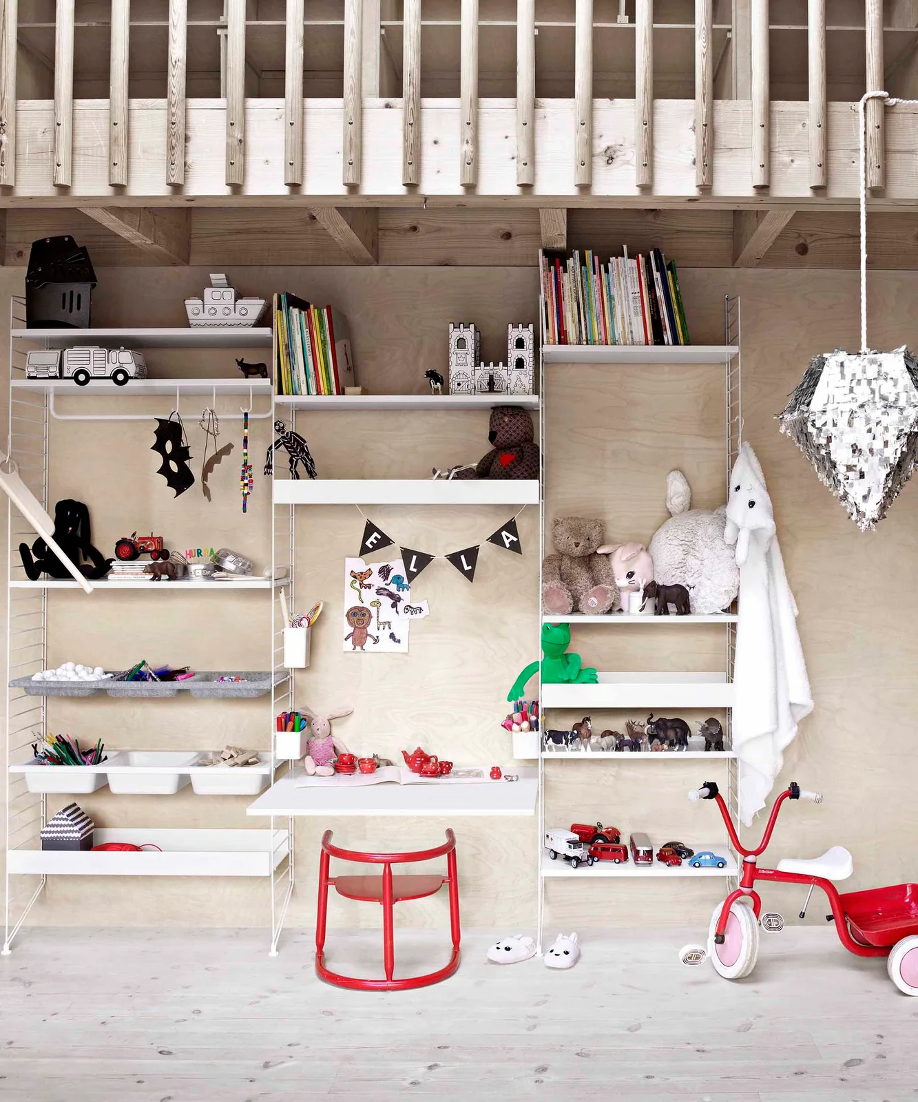 White modular wall shelves with books, soft toys, toy animals, cars and shallow creative-supply trays