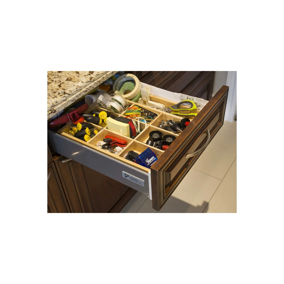 Wooden divided utility drawer holding tape, scissors, hand tools and small repair accessories