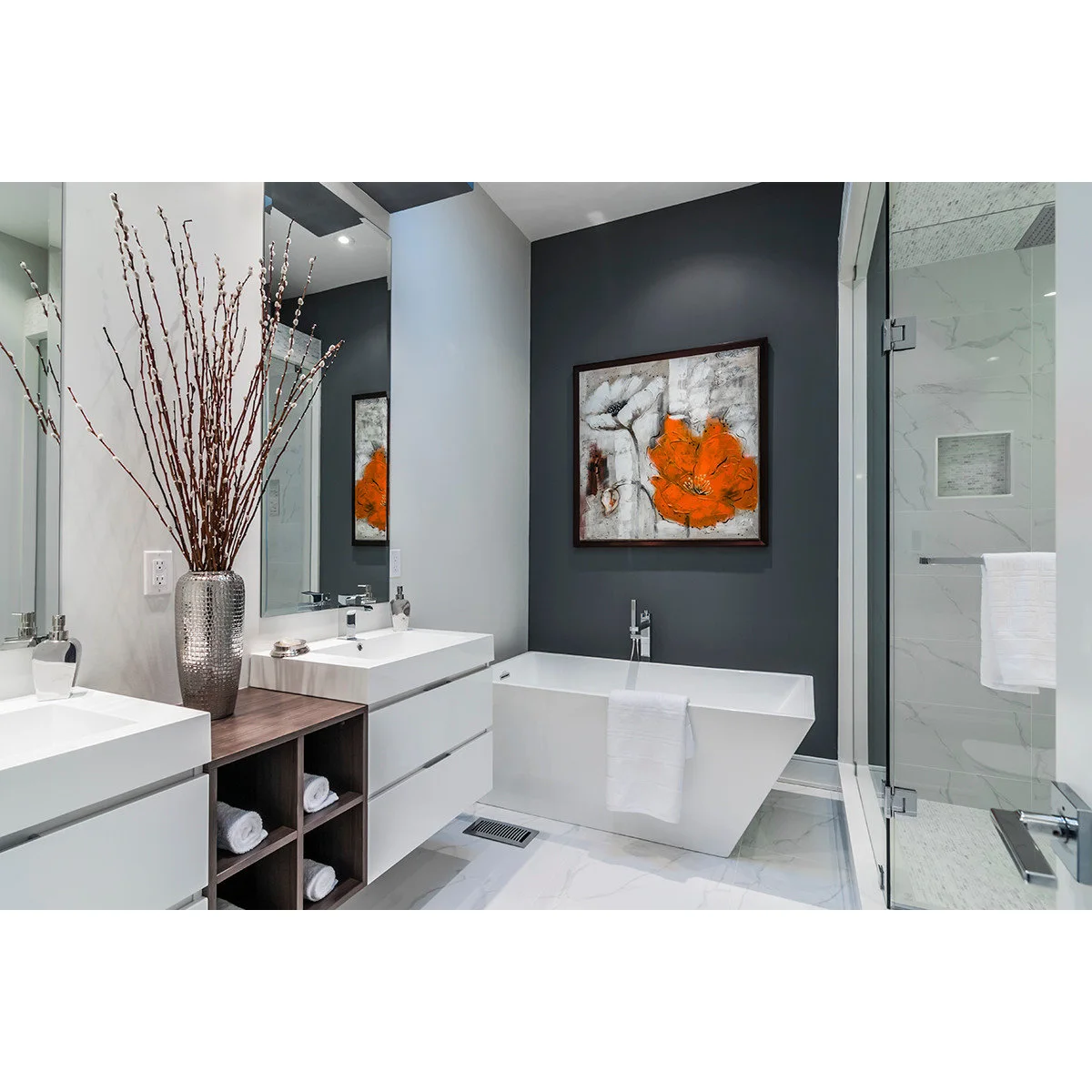 Orange-accent abstract picture above a white tub against a dark gray wall