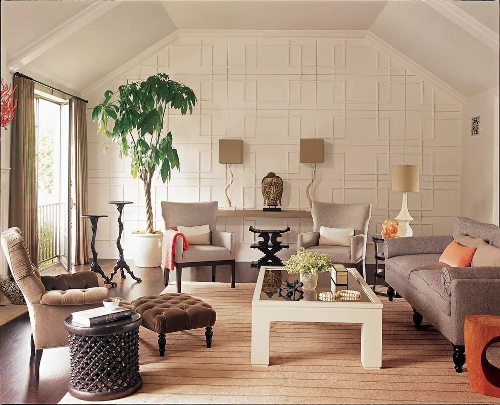 Pale rectangular paneling rises behind a living-room seating group