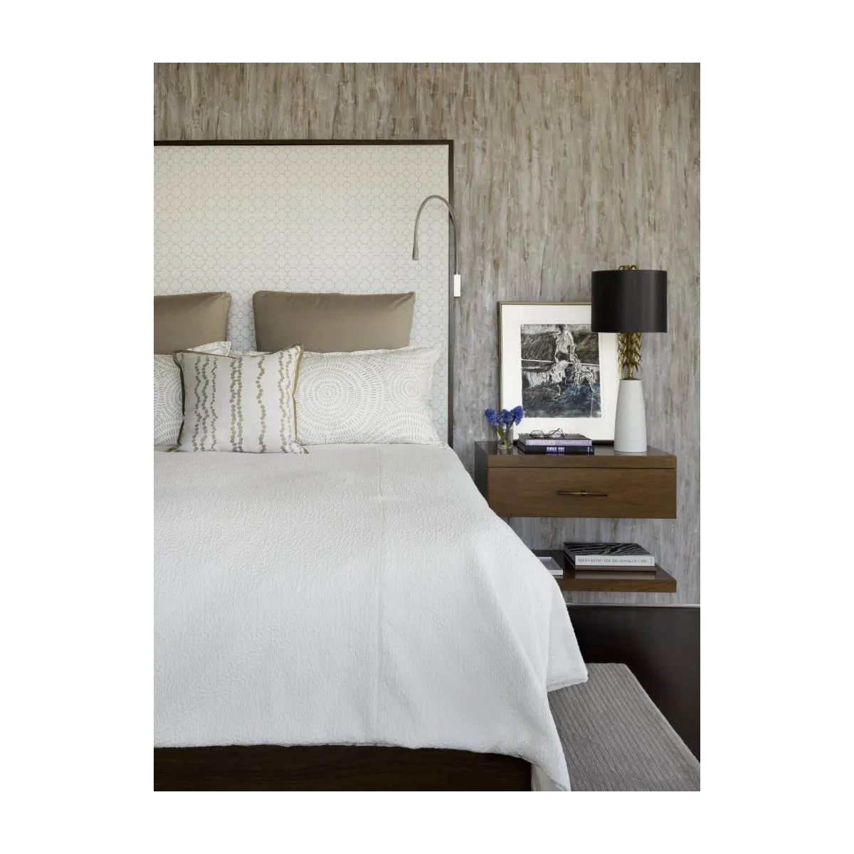 Floating wooden nightstand with one drawer and separate lower shelf against patterned wallpaper