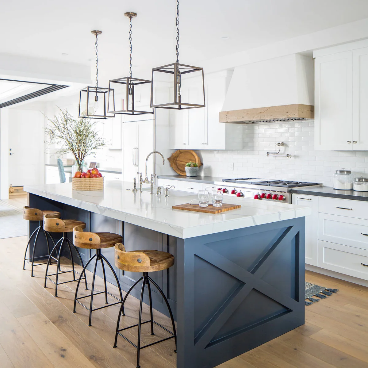 Blue kitchen island with a large X-shaped end panel and a pale countertop