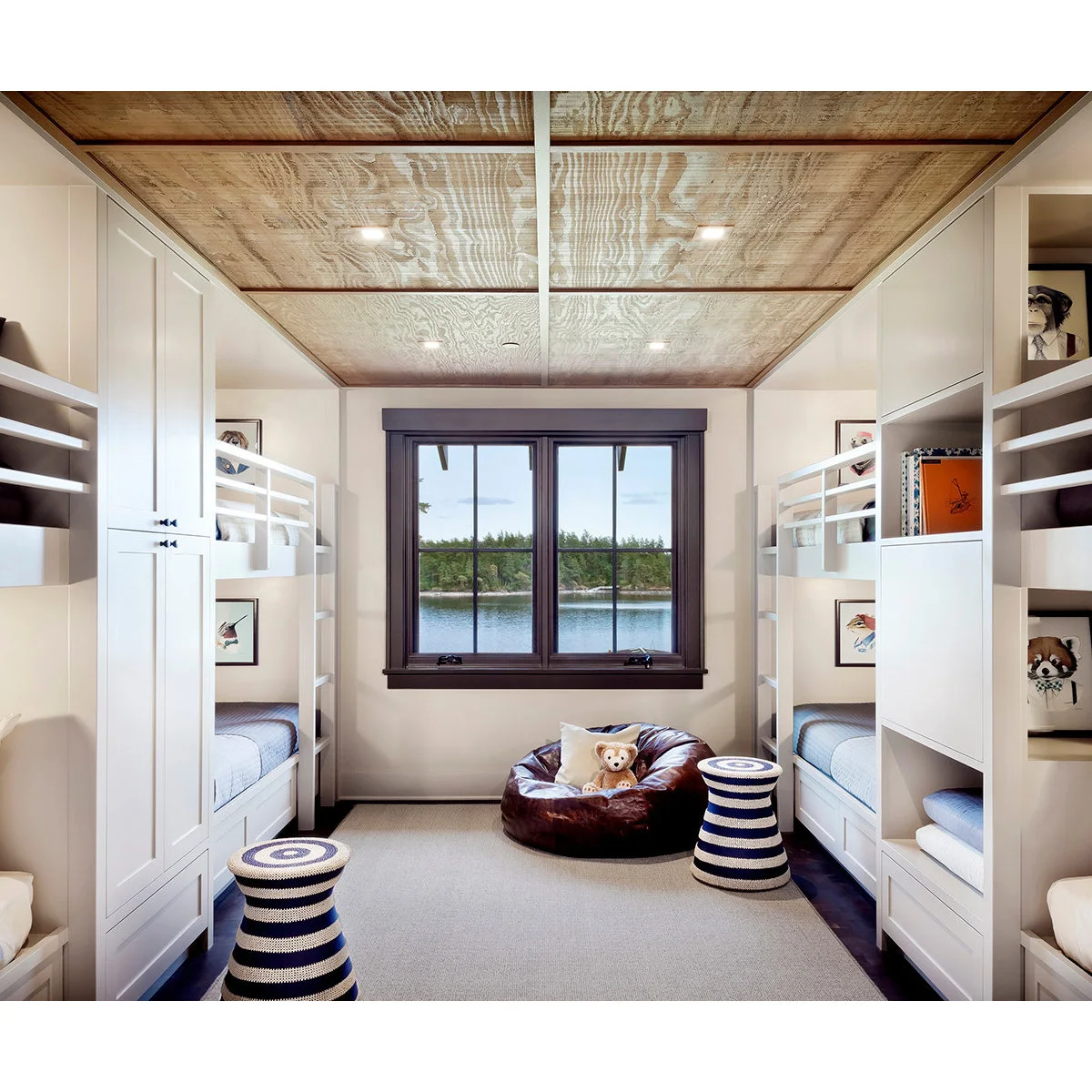 Wood panel ceiling with narrow dividing strips over a compact white bunk room
