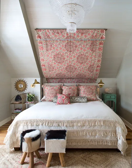 A patterned fabric panel follows the sloping wall above a pale bed.