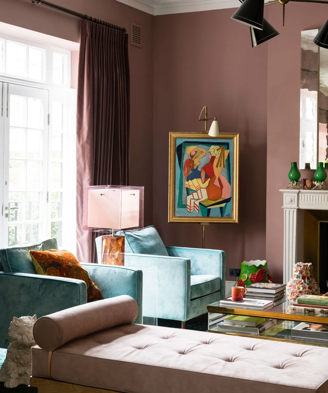 Muted pink walls surround pale blue chairs and varied smaller furniture.