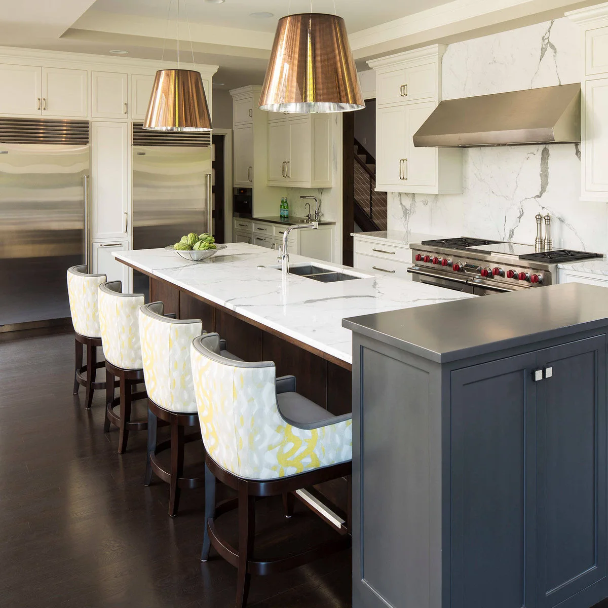 Matching white upper cupboards sit above two tall stainless appliances separated by a narrow cabinet.