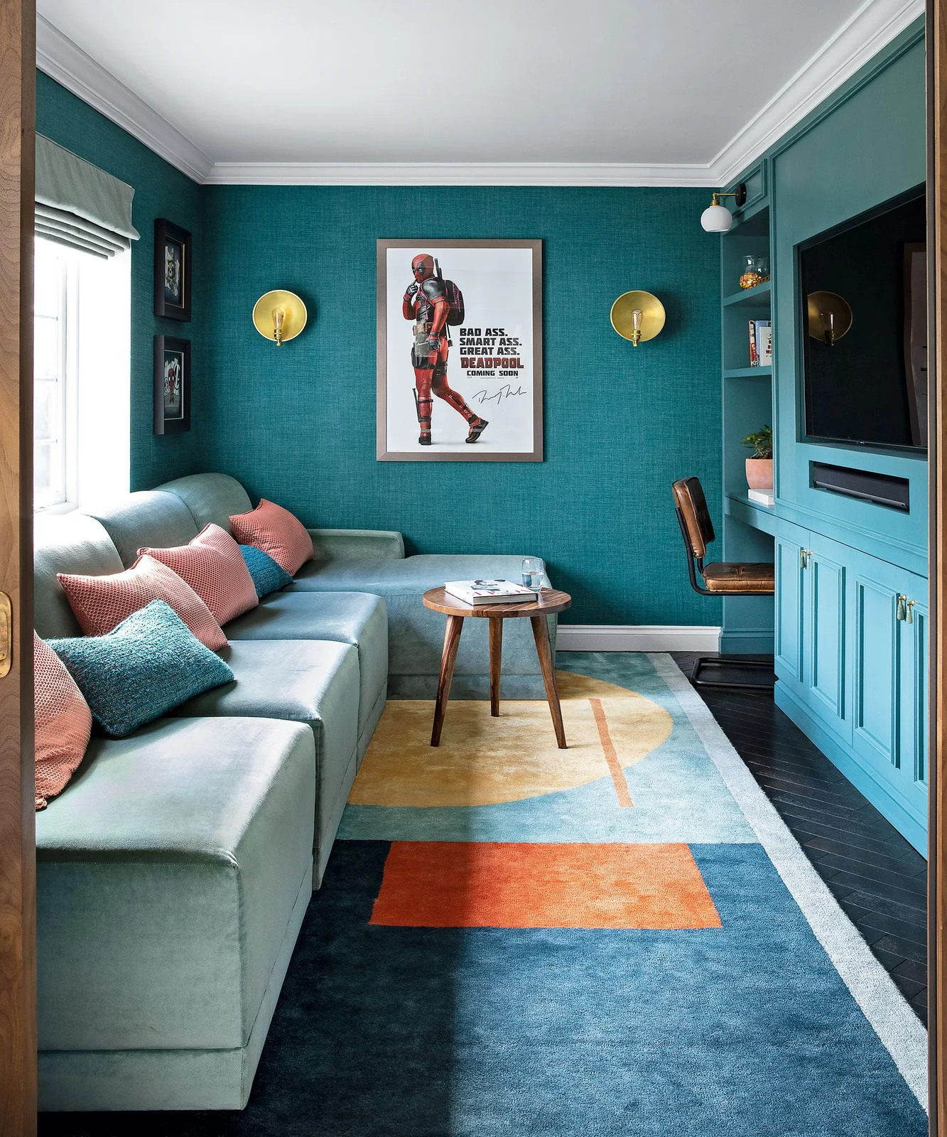 Teal sitting room with matching TV cabinet, pale sectional and small wooden table