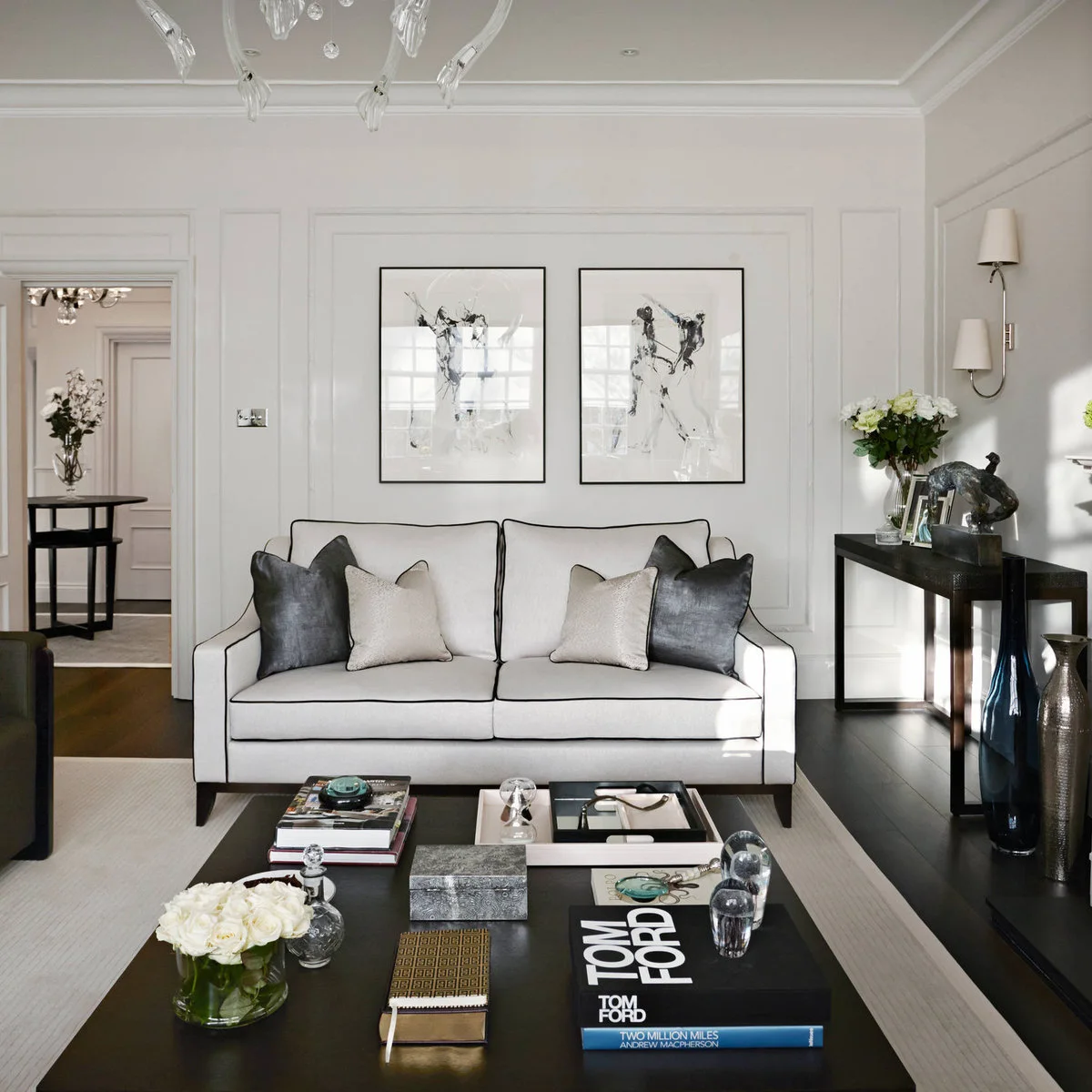 Pale sofa with black piping, dark console and large black coffee table