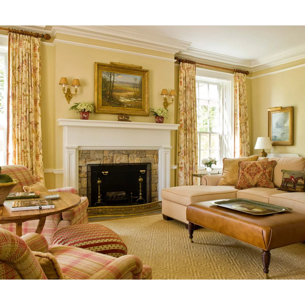 Traditional living room with butter-yellow walls, white fireplace trim, patterned curtains and a pale sectional sofa