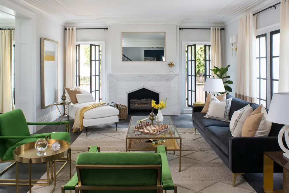 Green low-backed chairs face a dark sofa across a glass table in a bright living room