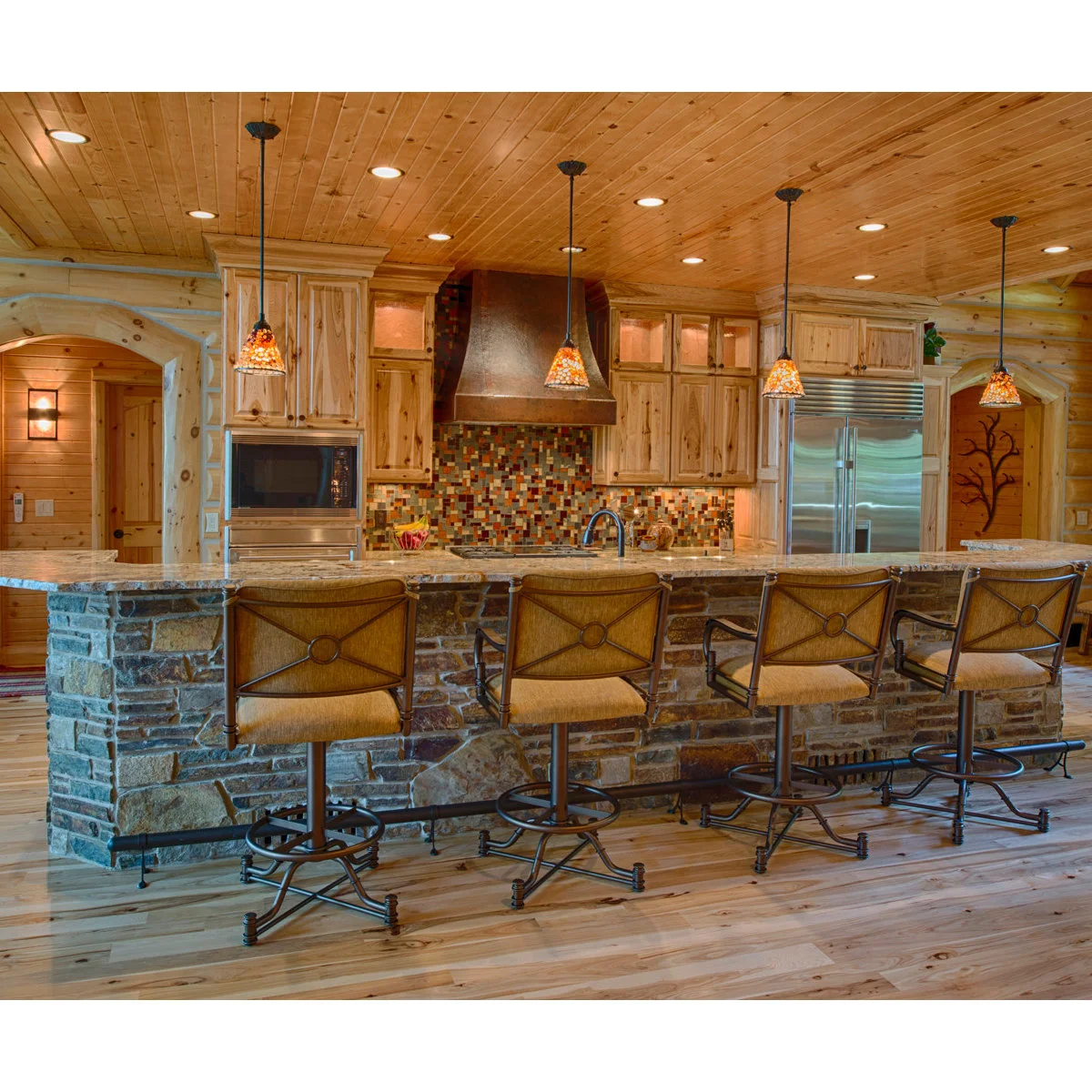 Rustic kitchen stools with upholstered arms and backs, decorative metal bases and oval foot rails