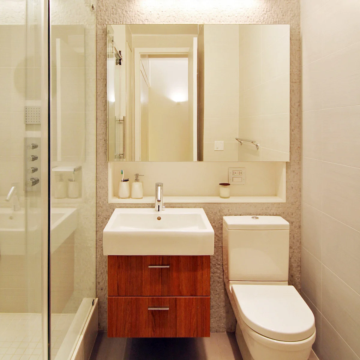 Compact wooden wall-hung vanity with two drawers beneath a broad mirrored wall unit