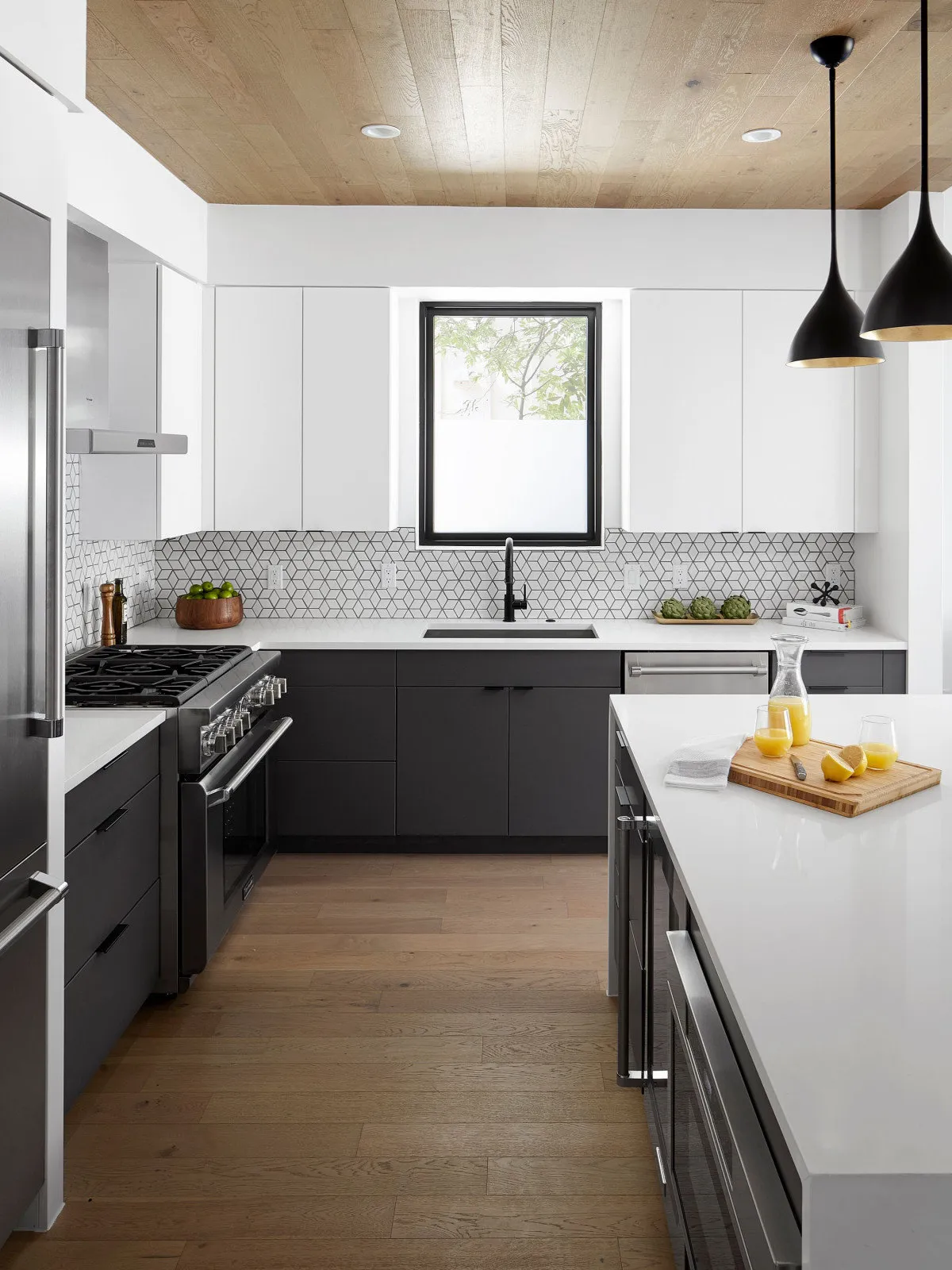 Dark lower cabinets sit beneath pale counters and white upper walls.