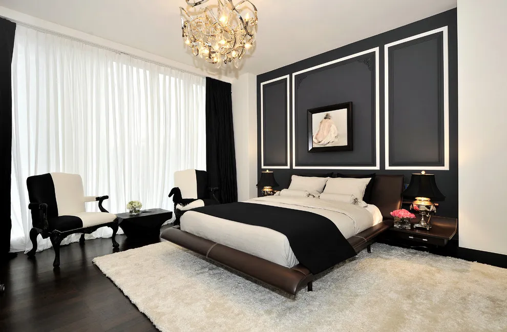 White rectangular trim outlines a black wall behind a pale bed and rug